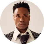 Billy Porter, Actor Billy Porter, wears a pinstriped suit jacket, white shirt, and dark tie, posing against a neutral background.